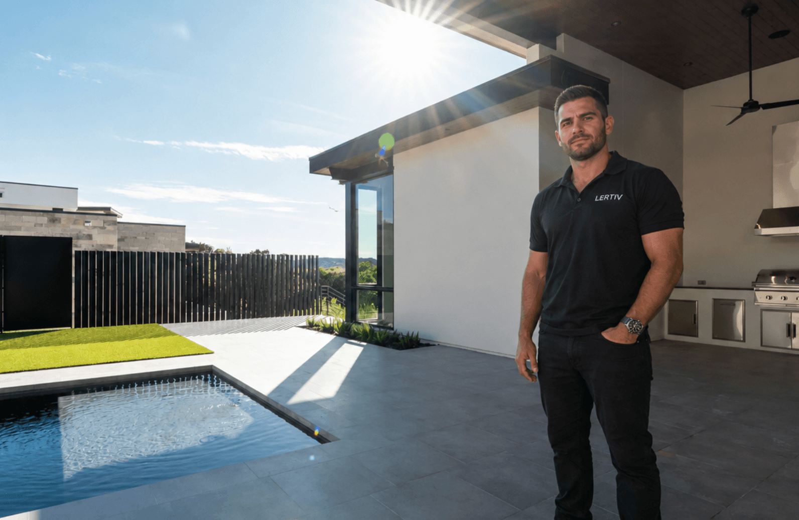 Adrian Veltri, founder of LERTIV, on a completed outdoor kitchen and pool project